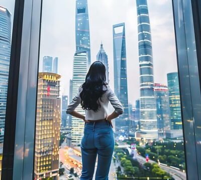 young-businesswoman-stand-her-back-camera-gazing-out-cityscape-towering-skyscraper-her-office_1289822-616